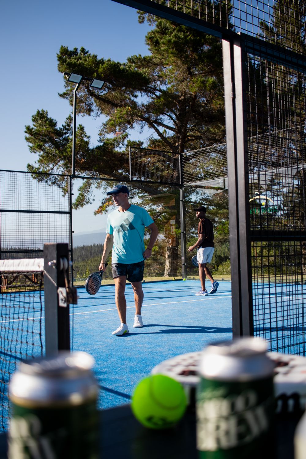Players on a blue padel court — illustrative stock photograph